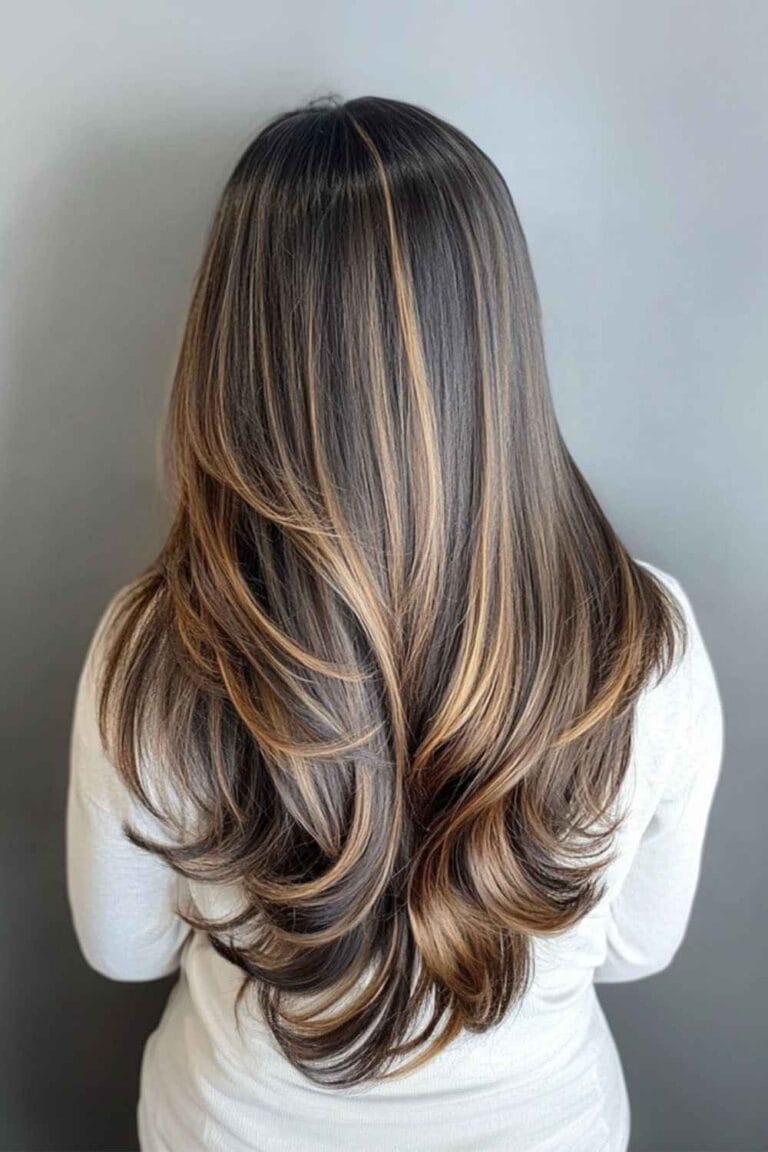 Trending Highlight Colors for Black Hair in 2025 Golden brown highlights and a V cut long