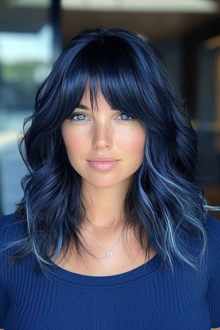 Trending Highlight Colors for Black Hair in 2025 Navy blue highlights and wispy bangs